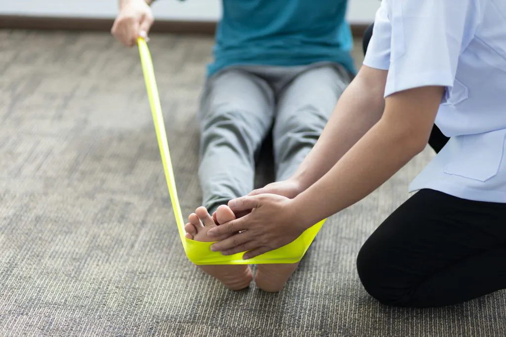 Physical therapists treat patients with exercises using latex therapy resistance band.